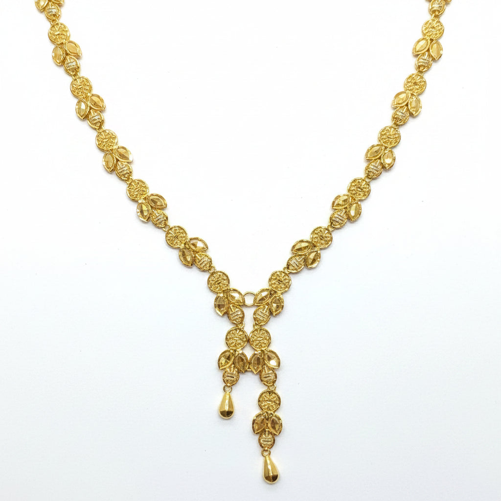 Gold necklace on a white card with a hand touching the top left corner.