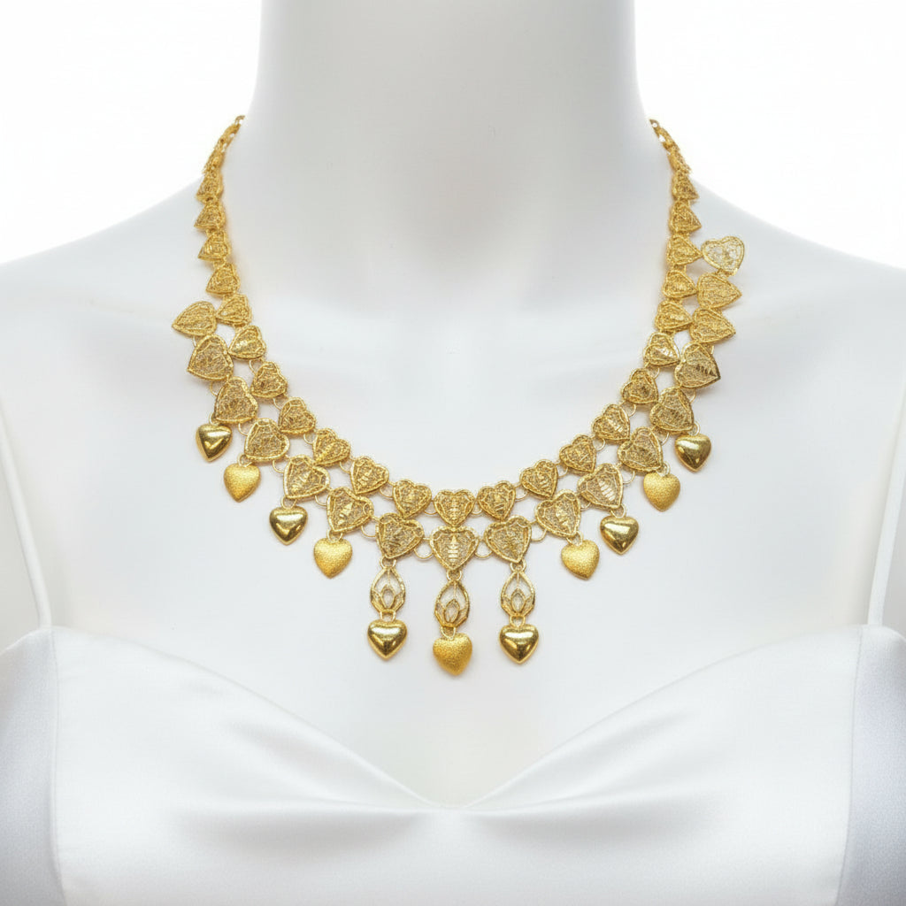 Gold necklace on a clear plastic card with a dark background