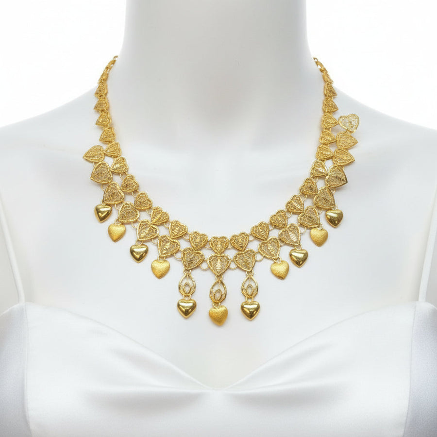 Gold necklace on a clear plastic card with a dark background