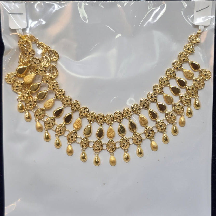 Gold necklace on a white card with a price tag.